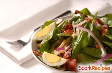 Mit warmem Speckdressing überbackener Spinatsalat